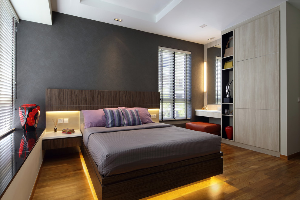 Inspiration for a contemporary grey and brown bedroom in Singapore with grey walls, dark hardwood flooring and brown floors.