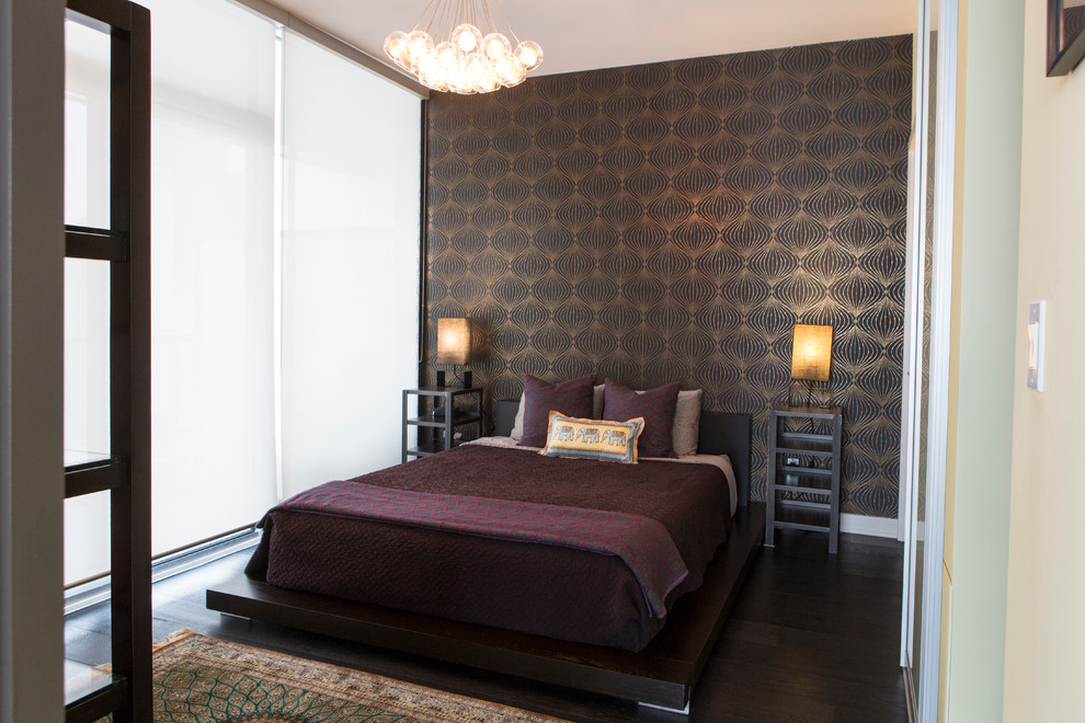 This is an example of a small world-inspired master bedroom in Toronto with black walls and dark hardwood flooring.