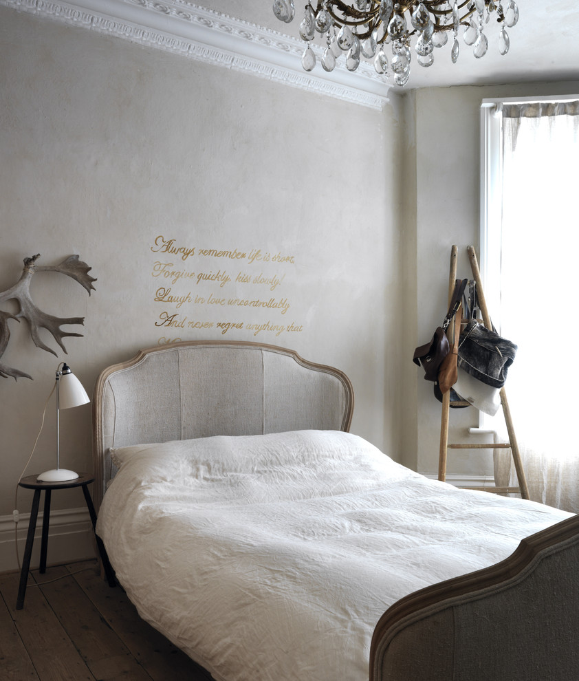 Imagen de dormitorio campestre con paredes grises y suelo de madera oscura