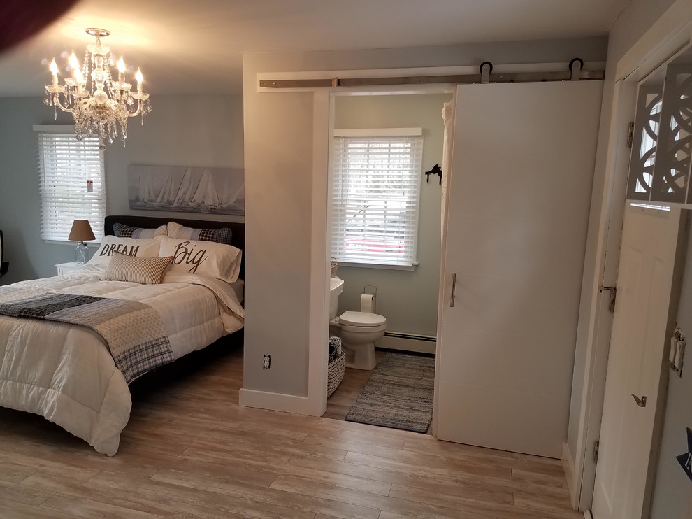 Photo of a contemporary master bedroom in Boston with laminate floors.