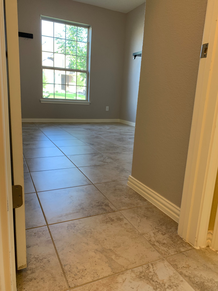 Photo of a medium sized contemporary guest bedroom in Austin with ceramic flooring, multi-coloured floors and grey walls.