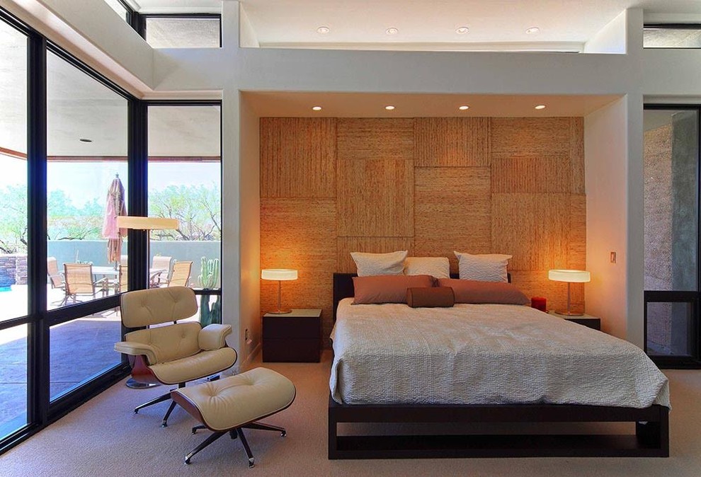 This is an example of a medium sized modern master bedroom in Phoenix with white walls, carpet and no fireplace.