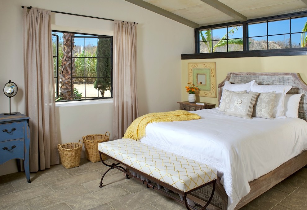 This is an example of a medium sized country guest bedroom in Other with concrete flooring and no fireplace.