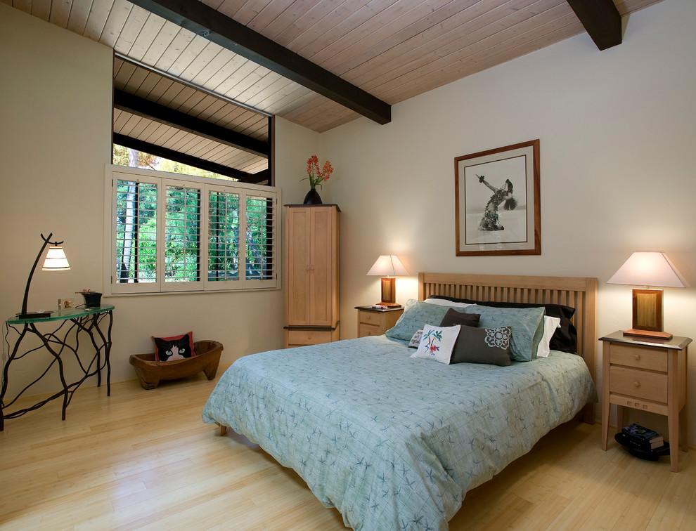 Example of a transitional light wood floor bedroom design in Santa Barbara with white walls