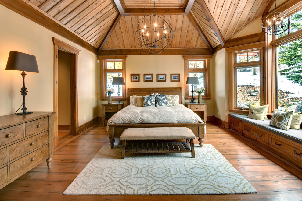 Bedroom - rustic medium tone wood floor, brown floor, vaulted ceiling and wood ceiling bedroom idea in Montreal with beige walls