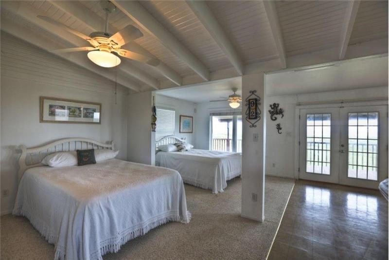 Small beach style carpeted and beige floor bedroom photo in Houston with white walls