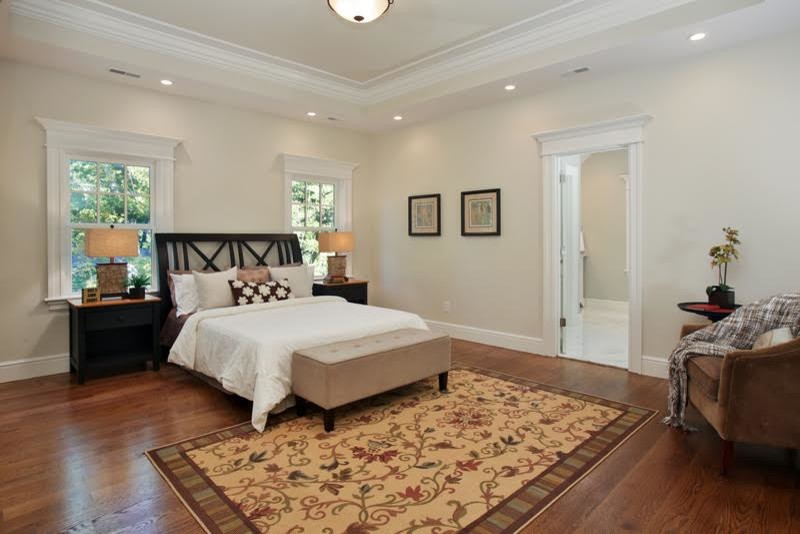 Design ideas for a large traditional master bedroom in Boston with beige walls, medium hardwood flooring and no fireplace.