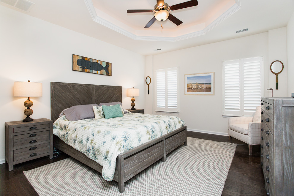 This is an example of a medium sized beach style guest bedroom in Other with white walls, no fireplace and dark hardwood flooring.