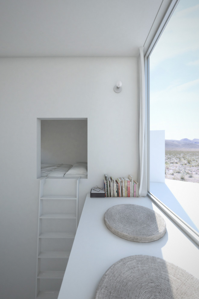 Immagine di una piccola camera da letto stile loft moderna con pareti bianche