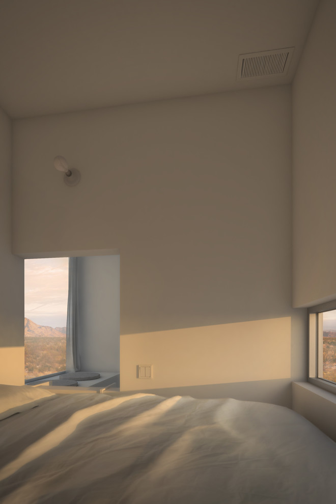 Inspiration pour une petite chambre mansardée ou avec mezzanine minimaliste avec un mur blanc.