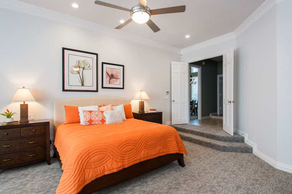 Medium sized classic master bedroom in Dallas with grey walls, carpet, a two-sided fireplace, a tiled fireplace surround and grey floors.