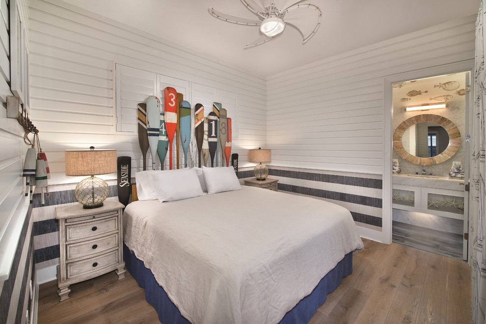 マイアミにある中くらいなビーチスタイルのおしゃれな寝室 (白い壁、暖炉なし、淡色無垢フローリング、ベージュの床) のレイアウト