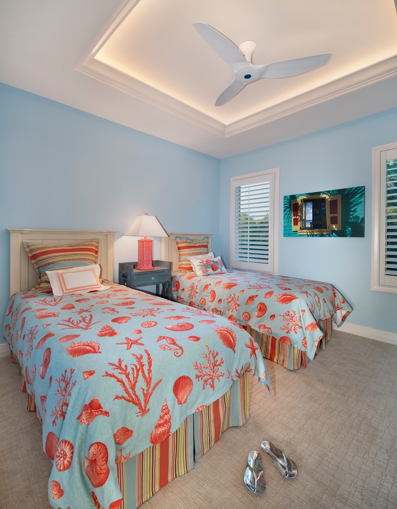 Inspiration for a mid-sized tropical guest carpeted and beige floor bedroom remodel in Miami with blue walls