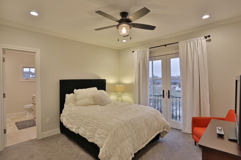 This is an example of a large classic guest bedroom in Austin with white walls, carpet and no fireplace.