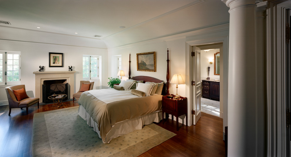 Example of a french country dark wood floor bedroom design in New York with white walls and a standard fireplace