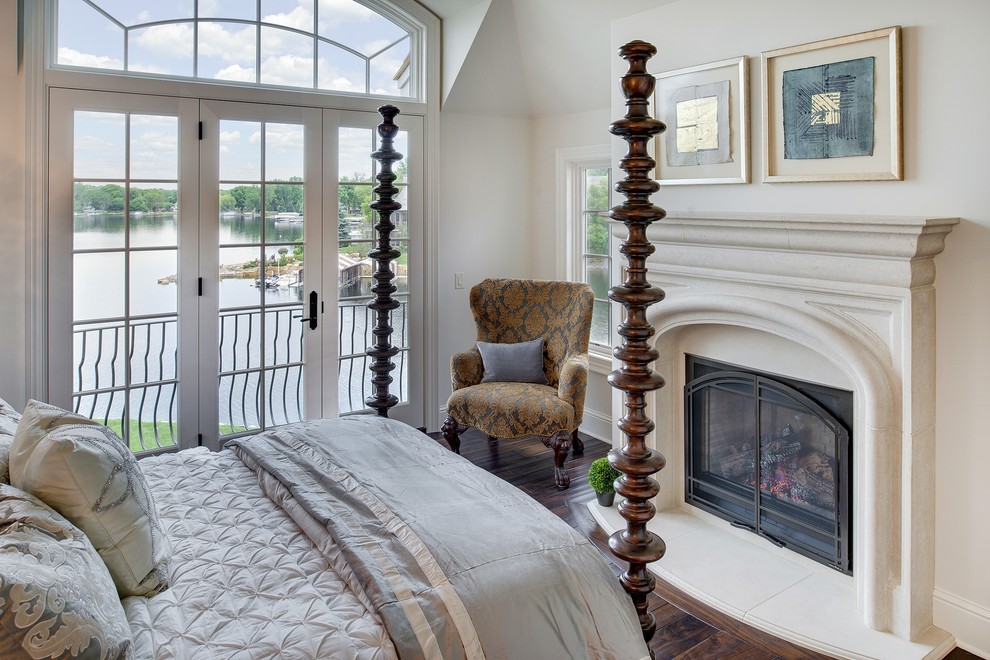 Inspiration for a french country master dark wood floor bedroom remodel in Minneapolis with white walls, a standard fireplace and a stone fireplace