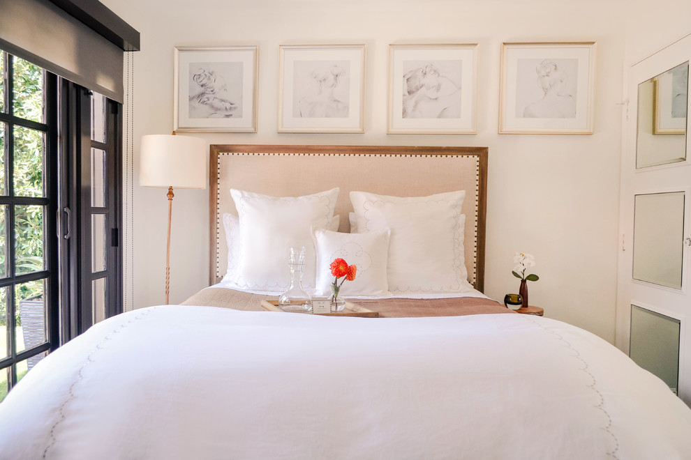 Example of a mid-sized transitional guest dark wood floor and brown floor bedroom design in Los Angeles with white walls and no fireplace