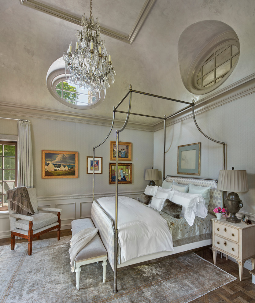 Classic master bedroom in New York with grey walls and feature lighting.
