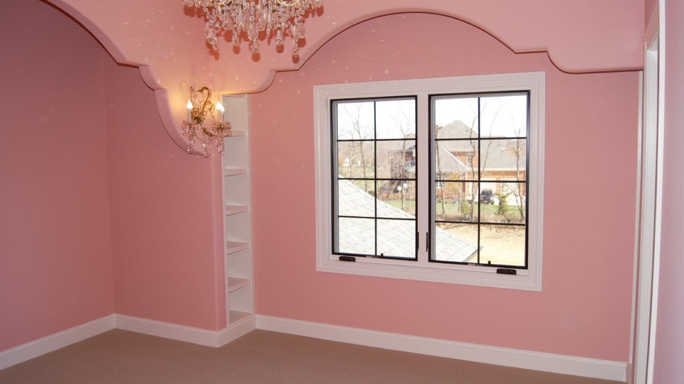 This is an example of a medium sized traditional guest bedroom in Columbus with pink walls, carpet and beige floors.