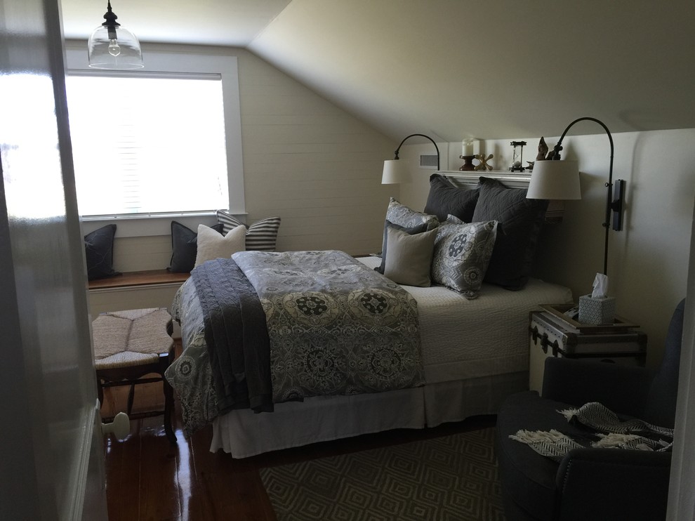 This is an example of a medium sized country guest bedroom in Raleigh with white walls, medium hardwood flooring and no fireplace.