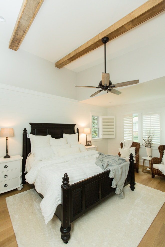 Imagen de dormitorio principal de estilo de casa de campo con paredes blancas, suelo de madera clara y suelo marrón