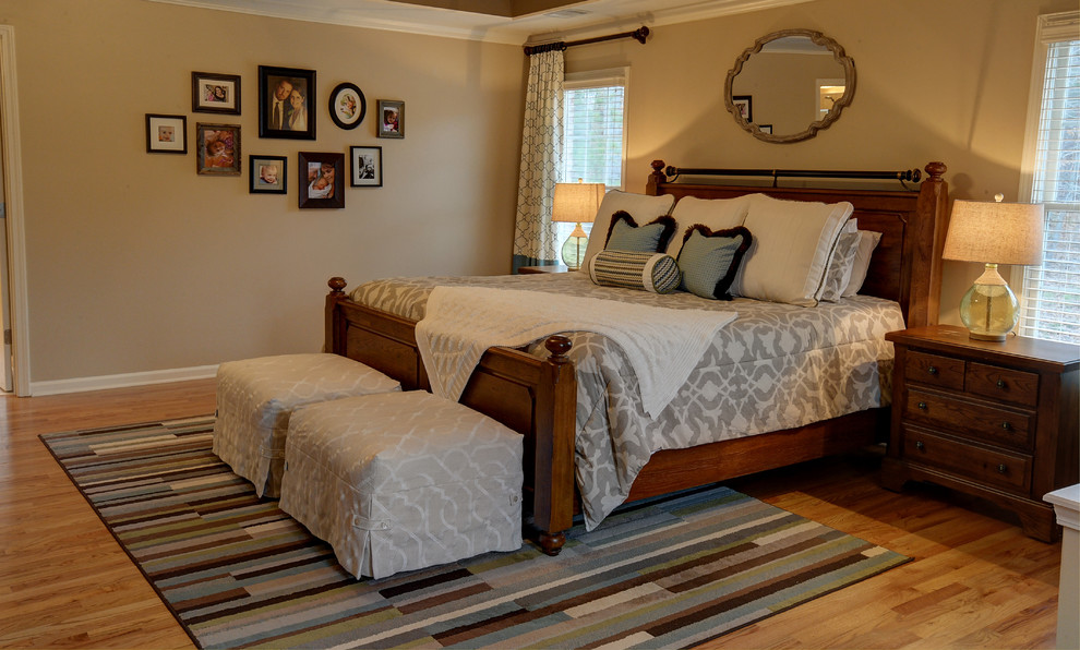 Mid-sized elegant master light wood floor bedroom photo in Atlanta with beige walls