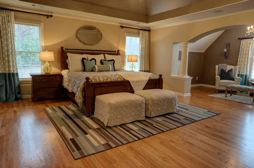 Example of a mid-sized classic master light wood floor bedroom design in Atlanta with beige walls