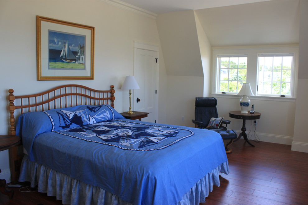 Modelo de dormitorio principal costero grande sin chimenea con paredes beige y suelo vinílico