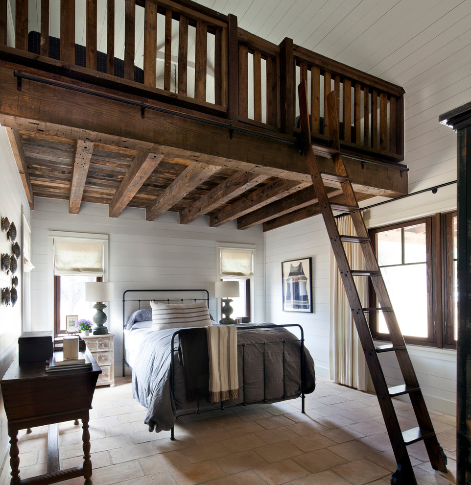 Inspiration for a country loft bedroom in Austin with white walls.