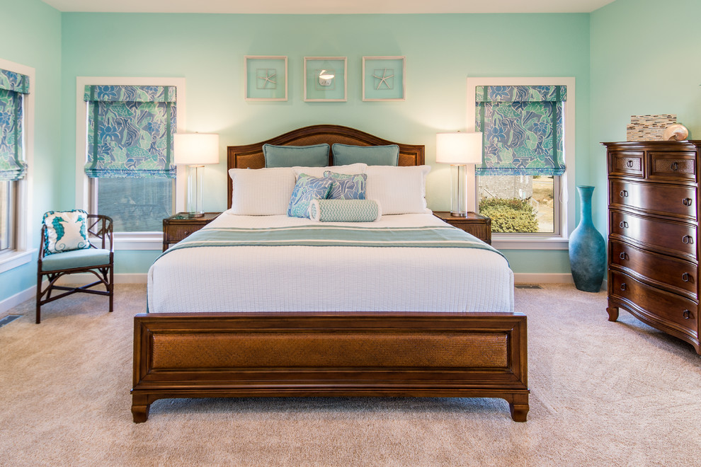 Design ideas for a large coastal master bedroom in Other with blue walls, carpet and beige floors.