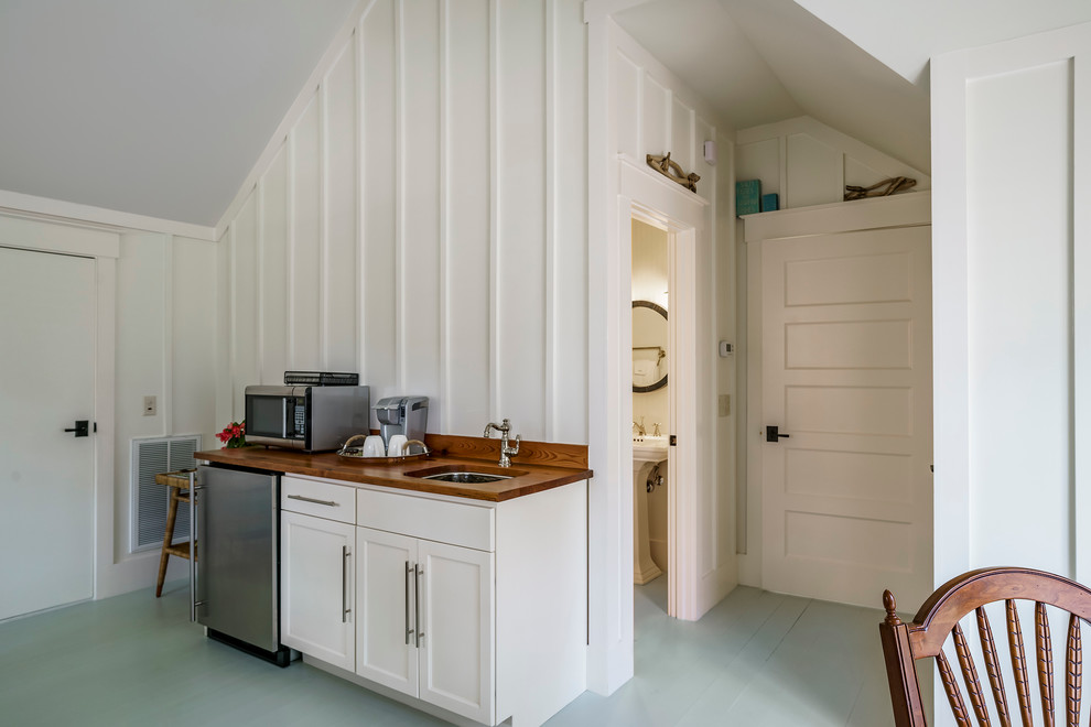 Modelo de habitación de invitados tradicional renovada de tamaño medio con paredes blancas y suelo de madera pintada