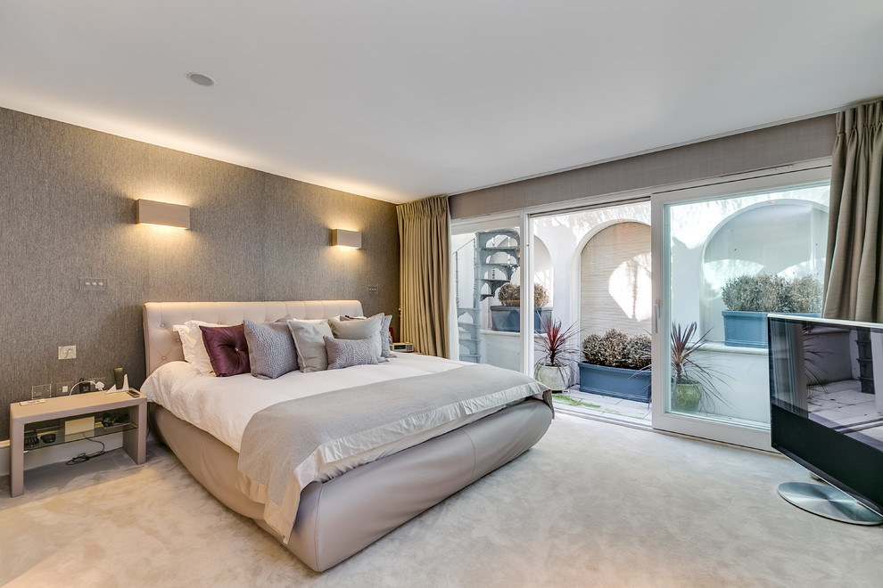 Design ideas for a medium sized contemporary master bedroom in London with beige walls, carpet, no fireplace and beige floors.