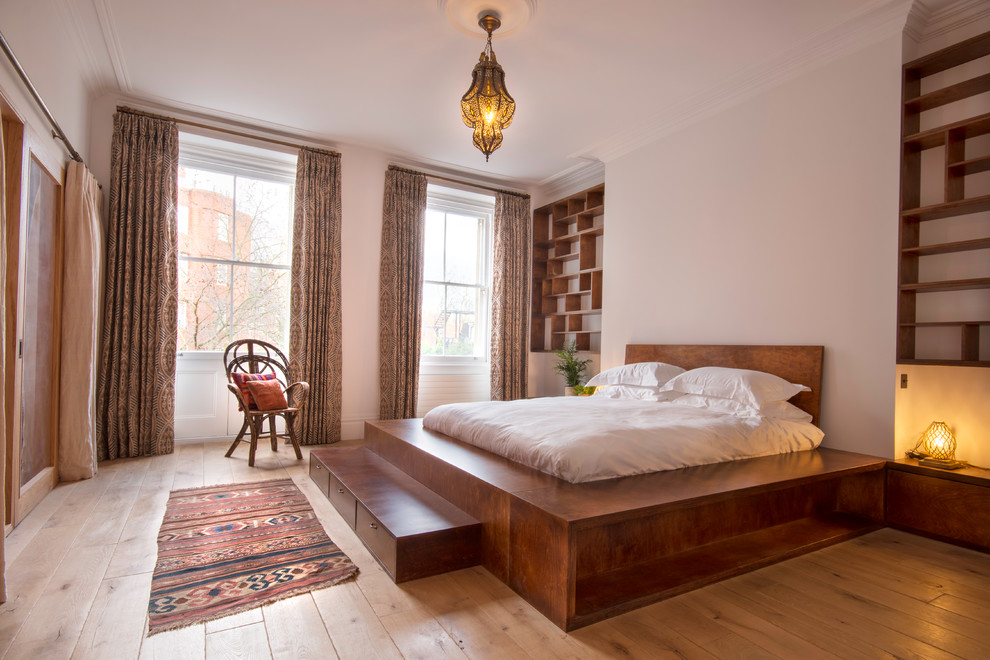 Großes Mediterranes Hauptschlafzimmer mit weißer Wandfarbe, hellem Holzboden und beigem Boden in London