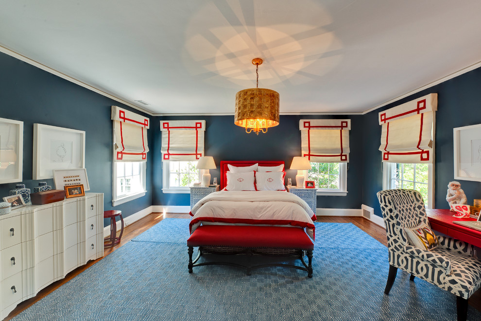 Example of an eclectic medium tone wood floor and blue floor bedroom design in Charlotte with blue walls