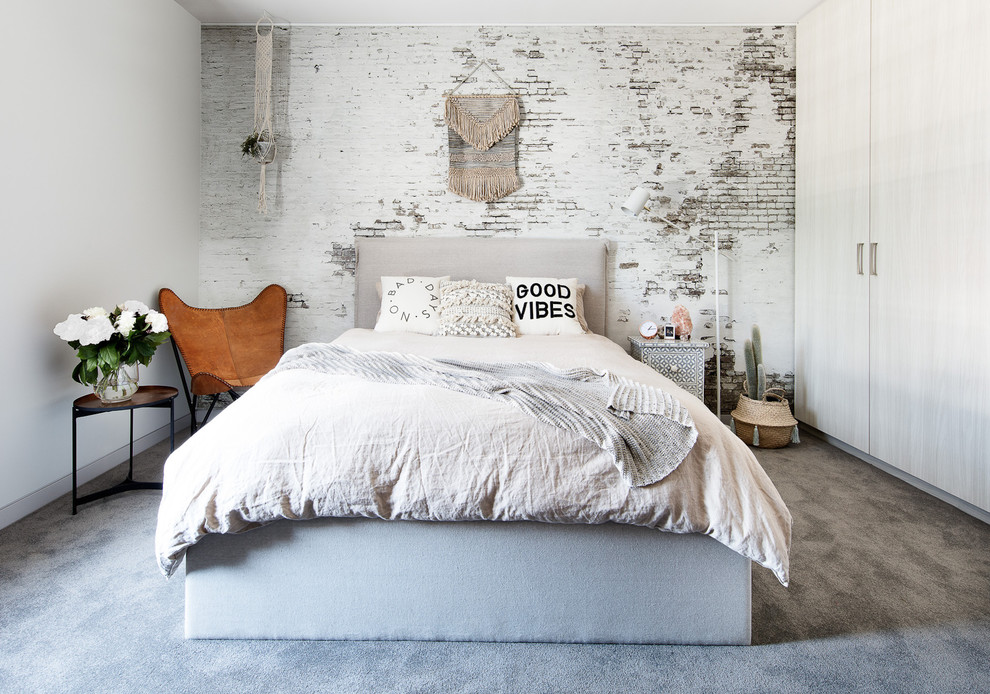 Photo of a vintage bedroom in Melbourne with white walls, carpet, grey floors and a feature wall.