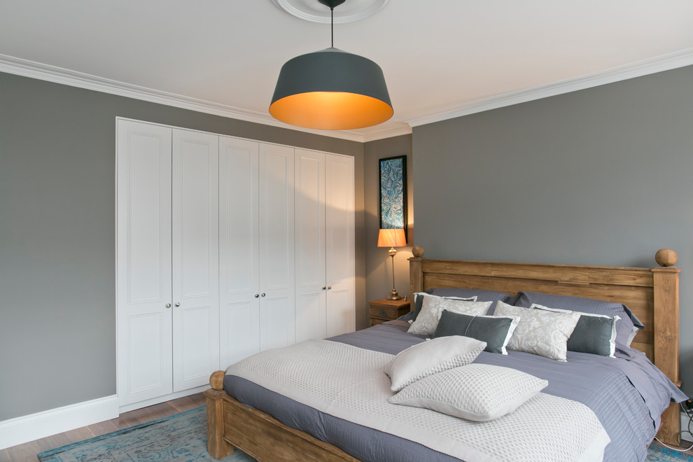 Example of a mid-sized transitional dark wood floor bedroom design in London