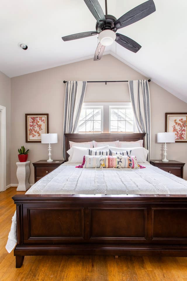 Modelo de habitación de invitados clásica renovada de tamaño medio con paredes beige, suelo de madera en tonos medios y suelo naranja