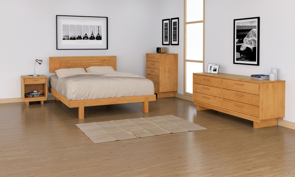 Large trendy master light wood floor and brown floor bedroom photo in New York with white walls and no fireplace