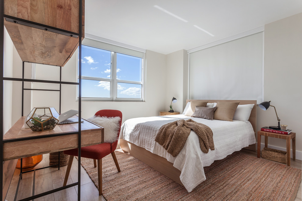 Inspiration for a transitional guest laminate floor and beige floor bedroom remodel in Miami with beige walls