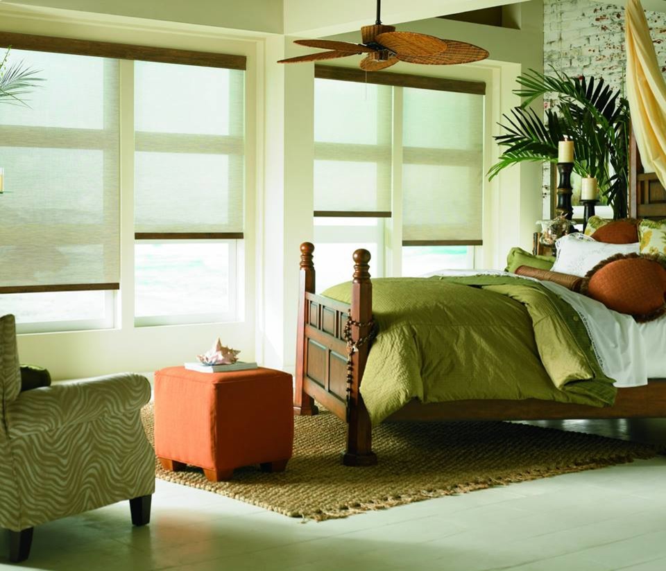 Example of a large island style master painted wood floor bedroom design in New York with beige walls and no fireplace