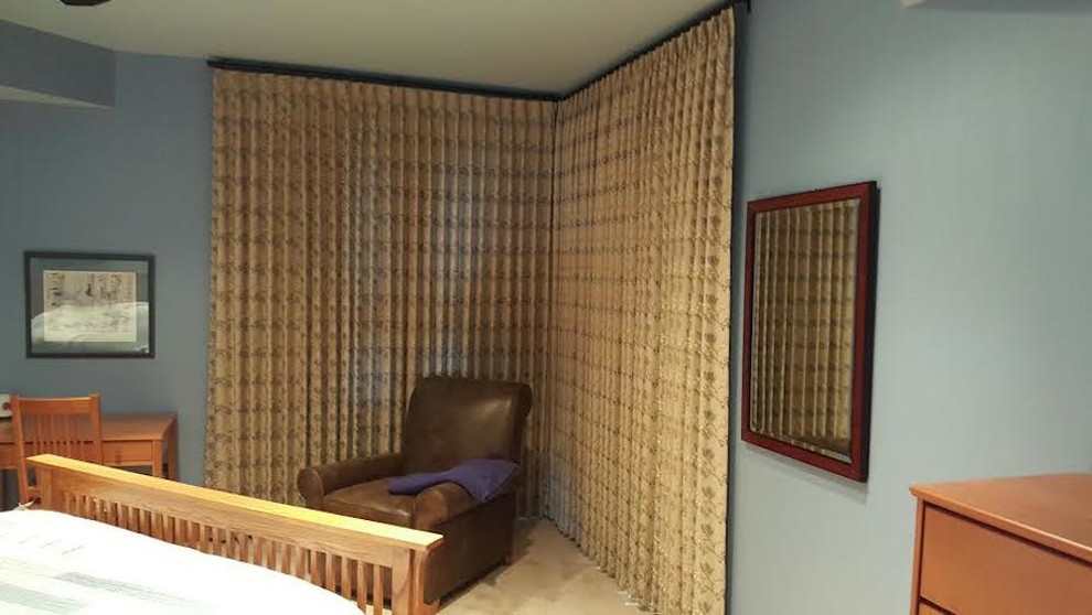 Imagen de dormitorio principal tradicional grande sin chimenea con paredes azules, suelo de piedra caliza y suelo beige