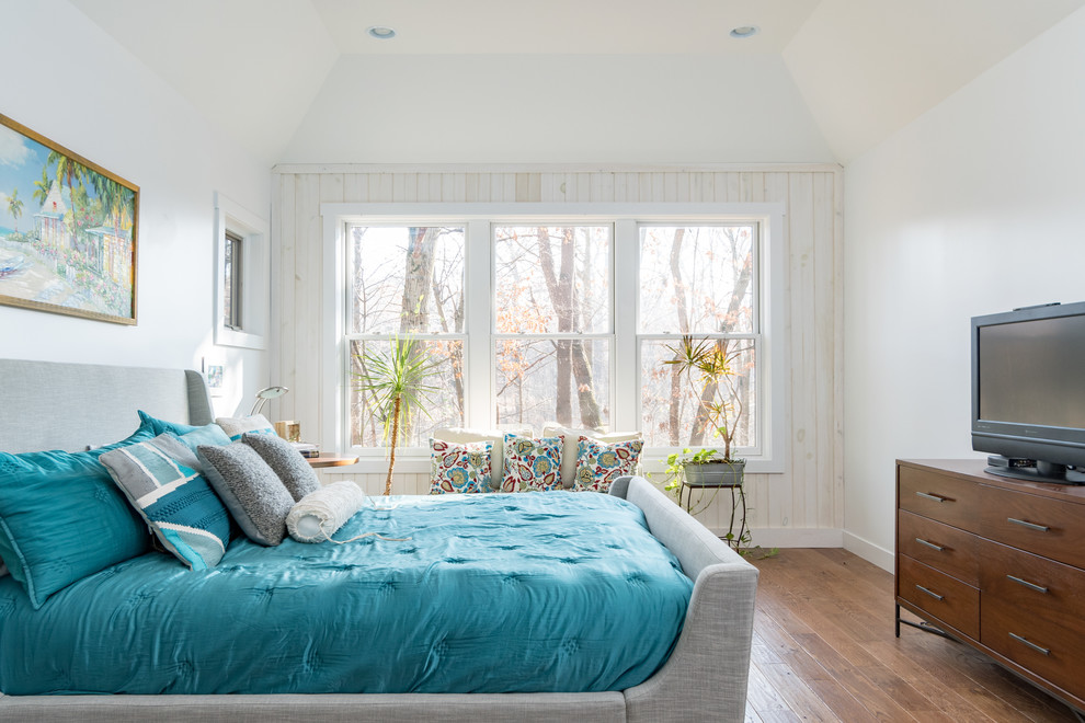 Example of an eclectic guest medium tone wood floor bedroom design in Grand Rapids with white walls