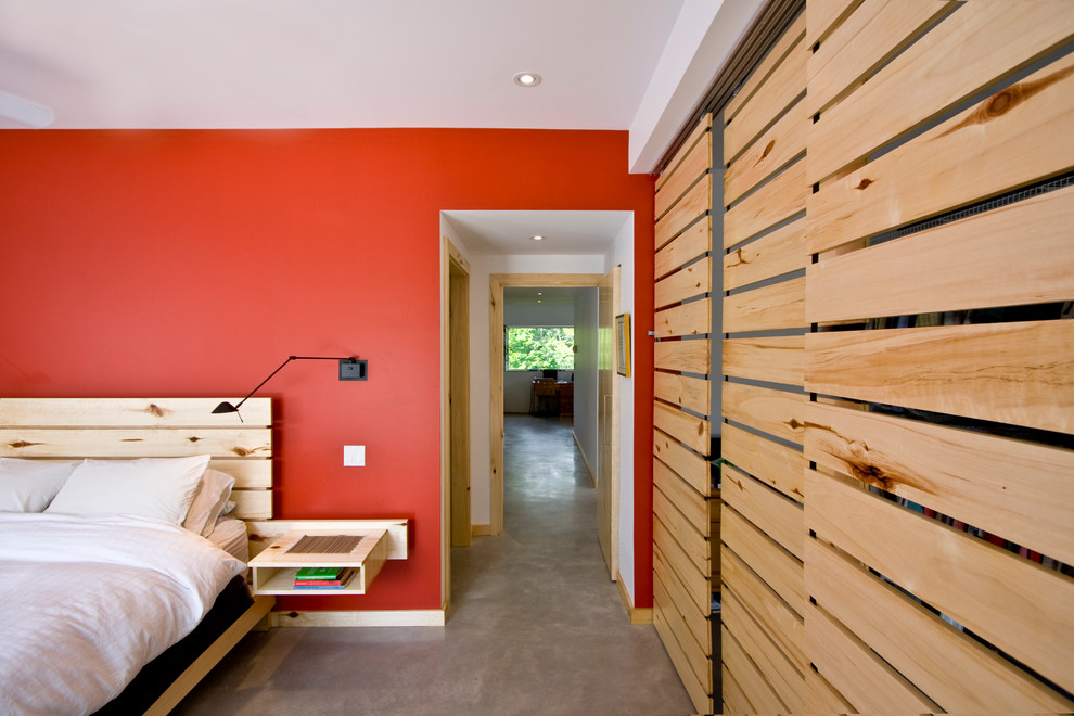 Contemporary bedroom in Toronto with concrete flooring.