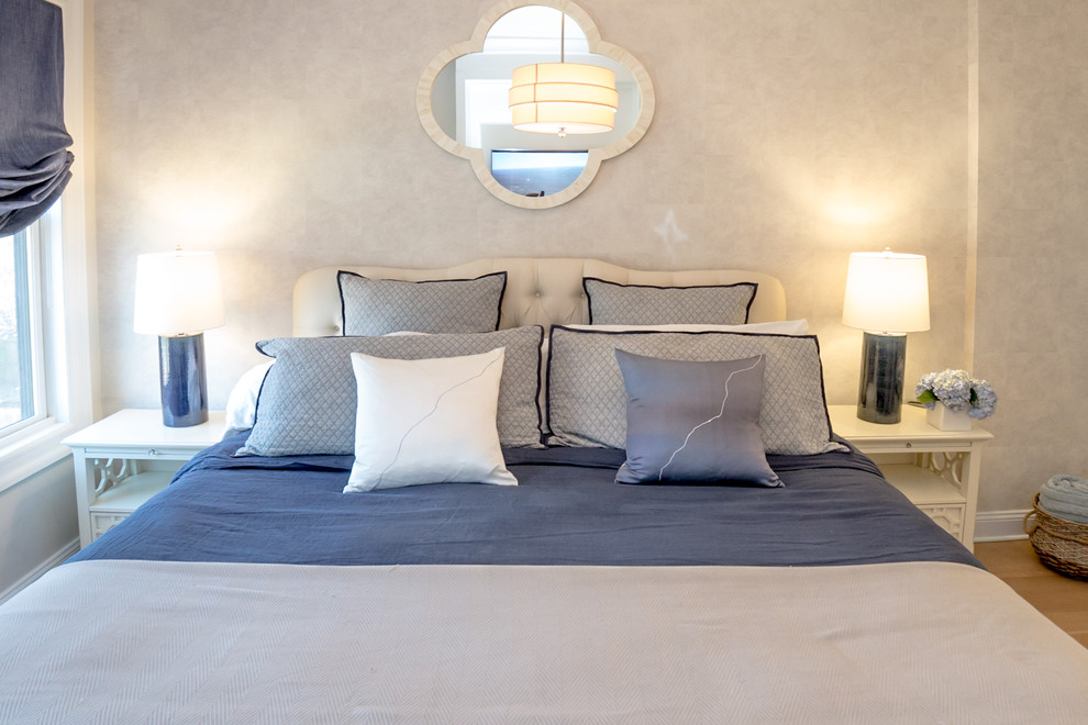 Ejemplo de dormitorio principal clásico renovado de tamaño medio sin chimenea con paredes beige, suelo de madera clara y suelo beige