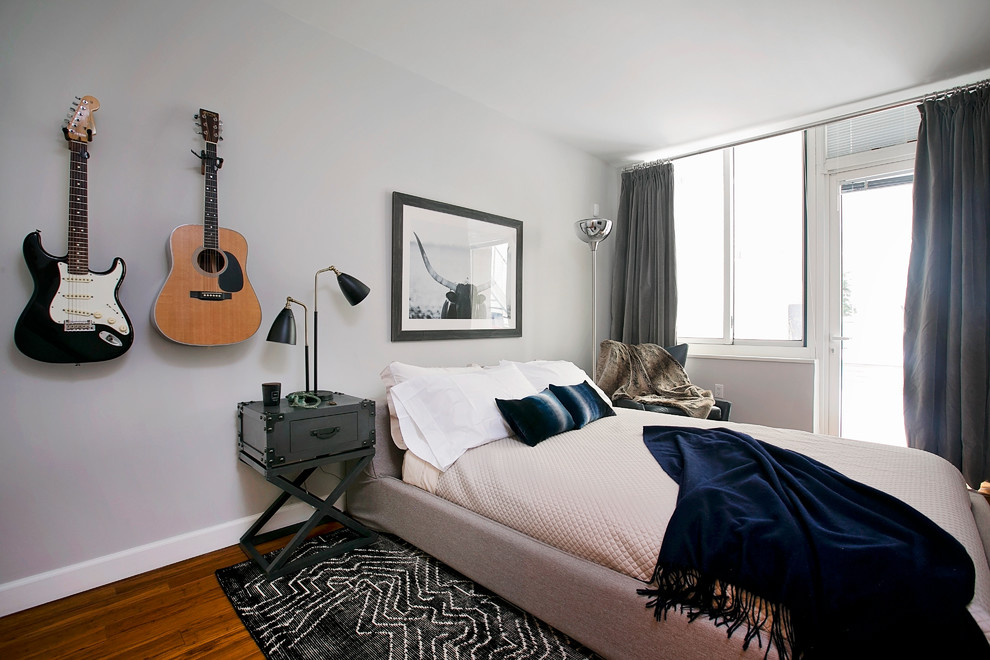 Photo of a medium sized contemporary guest bedroom in New York with grey walls and light hardwood flooring.