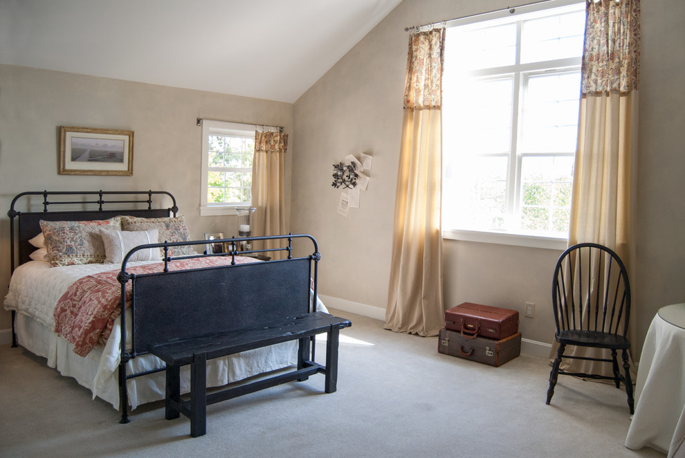 This is an example of a farmhouse bedroom in Cincinnati with beige walls and carpet.