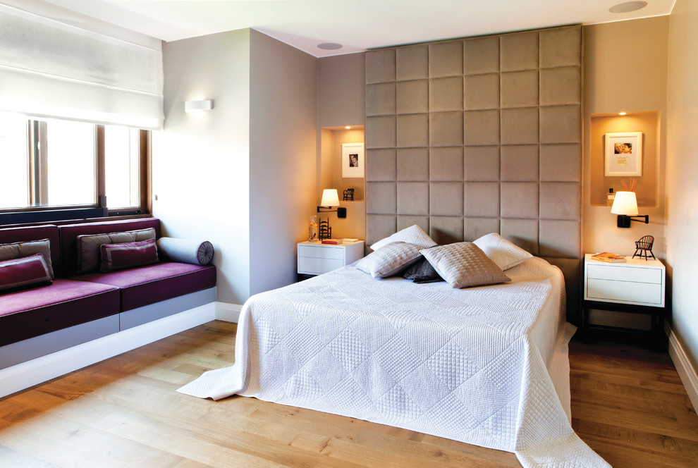 Photo of a contemporary bedroom in Other with grey walls.