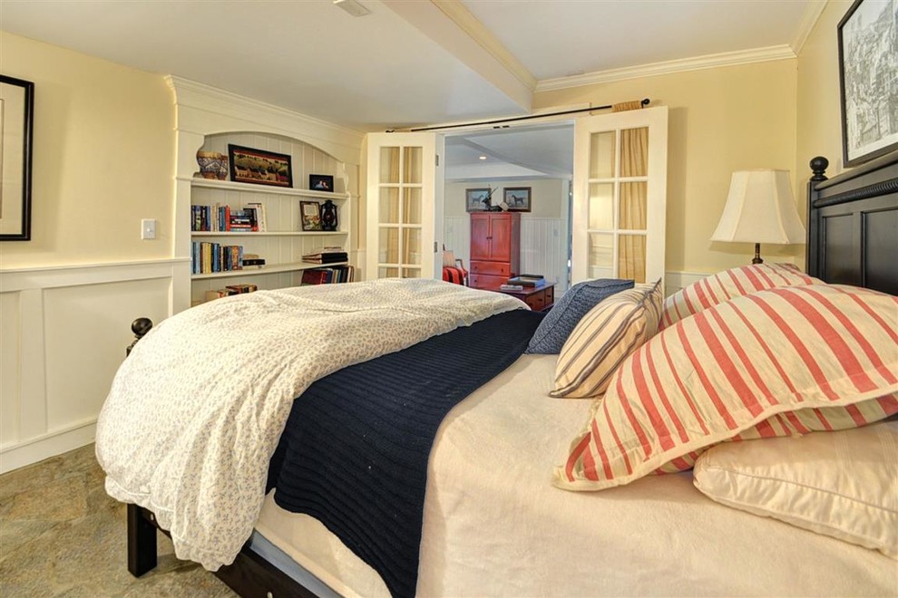 Пример оригинального дизайна: гостевая спальня среднего размера, (комната для гостей) в морском стиле с желтыми стенами и полом из известняка без камина