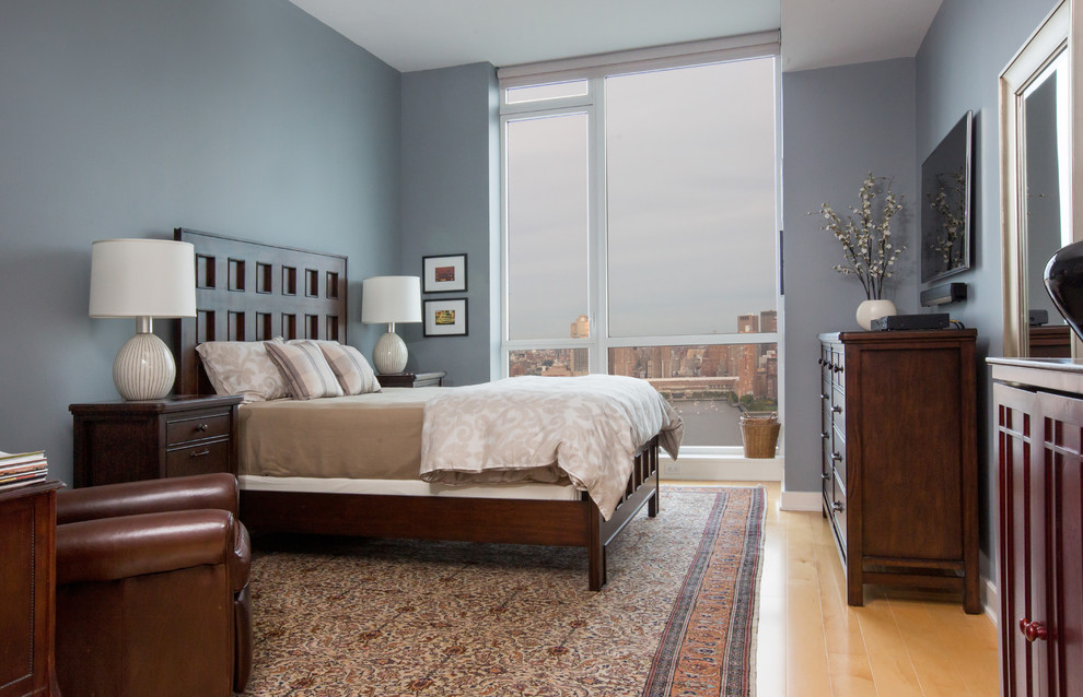 Example of a mid-sized transitional master light wood floor and beige floor bedroom design in Los Angeles with gray walls