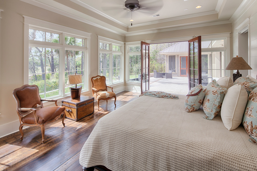Expansive traditional master bedroom in Atlanta with beige walls and medium hardwood flooring.